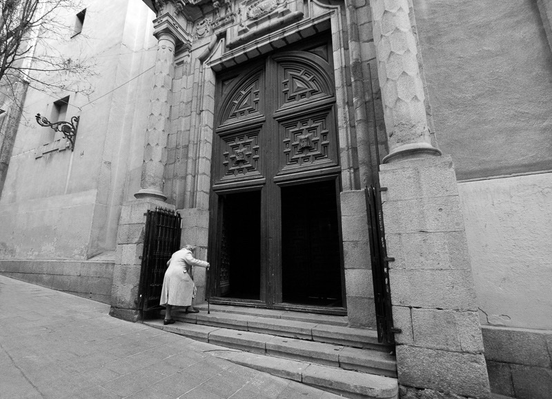 Old lady and church, Madrid, Spain

